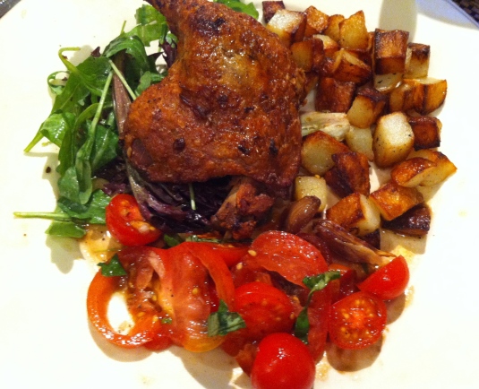 Duck Confit (w/ saute potatoes , tomatoes and rocket.
